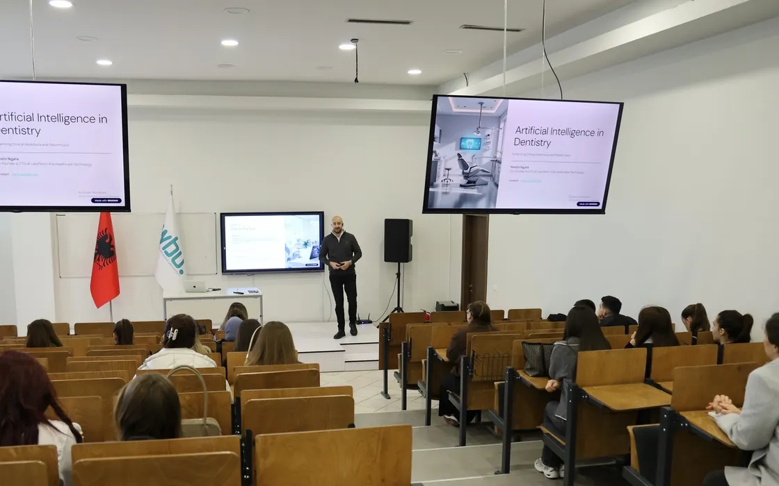 Lecture hall at Western Balkans University with students seated in rows and the title slide “Artificial Intelligence in Dentistry” on two screens.